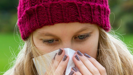 A woman is sick with a cold and needs a homeopathic remedy for cold and flu