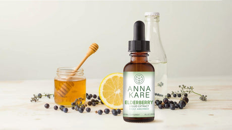 Elderberry extract bottle with honey, purified water, lemon, and fresh elderberries – ingredients for making homemade elderberry syrup.