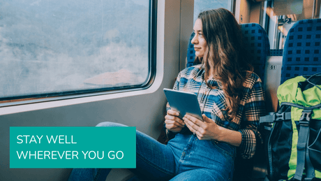 Woman looking out a train window during travel, symbolizing staying healthy and avoiding getting sick while traveling.